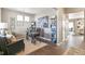 Home office features dark wood flooring, artwork and shelving, modern desk and comfortable seating at 3418 Belleville Ridge Rd, Elizabeth, CO 80107