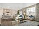 Open-concept living space with modern sofa, decorative pillows, and coffee table overlooking the kitchen area at 3418 Belleville Ridge Rd, Elizabeth, CO 80107