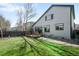 Large backyard with green grass, deck, and updated siding at 10774 W 107Th Cir, Broomfield, CO 80021