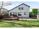 Backyard featuring lush green lawn, a small deck, and neutral colored siding at 10774 W 107Th Cir, Broomfield, CO 80021