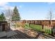 Wooden backyard deck overlooking grass and a tall wooden fence at 10774 W 107Th Cir, Broomfield, CO 80021