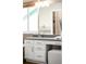 Bright bathroom with double vanity featuring framed mirror, modern fixtures, and white cabinets offers a modern retreat at 10774 W 107Th Cir, Broomfield, CO 80021