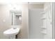 Neutral colored bathroom featuring a pedestal sink and walk-in shower at 10774 W 107Th Cir, Broomfield, CO 80021