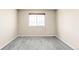 A spacious bedroom with neutral carpet and a large window offering ample natural light at 10774 W 107Th Cir, Broomfield, CO 80021