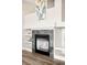Close-up of a cozy fireplace with a tiled surround and built-in shelving at 10774 W 107Th Cir, Broomfield, CO 80021