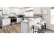 Eat in kitchen with breakfast bar seating, white cabinets, and stainless steel appliances at 10774 W 107Th Cir, Broomfield, CO 80021