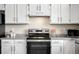 Close up of the kitchen featuring white cabinets, stone countertops, and stainless steel oven at 10774 W 107Th Cir, Broomfield, CO 80021