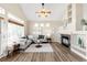 Open living area with a vaulted ceiling, fireplace, and a comfortable gray sectional sofa at 10774 W 107Th Cir, Broomfield, CO 80021