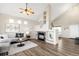 Bright, open-concept living area featuring a fireplace and vaulted ceilings at 10774 W 107Th Cir, Broomfield, CO 80021