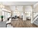 Bright living room features vaulted ceilings, wood floors, fireplace, and large windows at 10774 W 107Th Cir, Broomfield, CO 80021