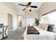 Cozy bedroom features a ceiling fan, a large window, and ensuite bathroom entrance at 10774 W 107Th Cir, Broomfield, CO 80021