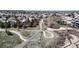Picturesque aerial view of a residential neighborhood with winding paths and lush landscaping, perfect for leisurely strolls at 9559 Brook Hill Ln, Lone Tree, CO 80124