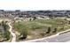 Expansive aerial view of a park with soccer fields, walking paths, trees and urban landscape in the distance at 9559 Brook Hill Ln, Lone Tree, CO 80124