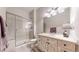 Updated bathroom featuring a tiled shower with glass doors and a stylish vanity at 9559 Brook Hill Ln, Lone Tree, CO 80124