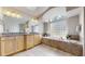 Beautiful bathroom with granite countertop vanities, tile flooring, and a skylight at 9559 Brook Hill Ln, Lone Tree, CO 80124