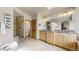 Spacious bathroom featuring dual sink vanity, granite countertops, and a walk-in shower with glass enclosure at 9559 Brook Hill Ln, Lone Tree, CO 80124