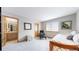 Cozy bedroom boasts neutral colors, plush carpet, and an ensuite bathroom for added privacy and convenience at 9559 Brook Hill Ln, Lone Tree, CO 80124