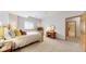 Bright bedroom with a full bed, dresser, and en suite bathroom with a walk-in shower at 9559 Brook Hill Ln, Lone Tree, CO 80124