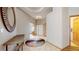 Welcoming foyer features a marble floor, rounded mirror and front door leading to a study at 9559 Brook Hill Ln, Lone Tree, CO 80124