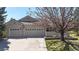 Inviting front exterior featuring a two-car garage, extended driveway, manicured lawn and mature landscaping around property at 9559 Brook Hill Ln, Lone Tree, CO 80124