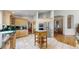 Open kitchen features light wood cabinets, a center island, and tile flooring at 9559 Brook Hill Ln, Lone Tree, CO 80124