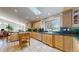 Sunlit kitchen features tile floors, light wood cabinets, stainless steel appliances and a skylight at 9559 Brook Hill Ln, Lone Tree, CO 80124