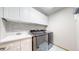 Efficient laundry room with modern appliances, stylish backsplash, and functional cabinetry at 9559 Brook Hill Ln, Lone Tree, CO 80124