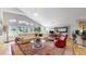 Bright living room with hardwood floors, an area rug, and an open floor plan connecting to the kitchen at 9559 Brook Hill Ln, Lone Tree, CO 80124