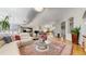 Open concept living room with hardwood flooring, skylights, comfortable seating and view into other parts of the home at 9559 Brook Hill Ln, Lone Tree, CO 80124