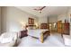 Spacious main bedroom with carpet, ceiling fan, and two end tables with lamps at 9559 Brook Hill Ln, Lone Tree, CO 80124