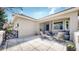 Outdoor patio features tiled flooring and seating with comfortable chairs and lovely landscaping at 9559 Brook Hill Ln, Lone Tree, CO 80124