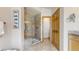 Updated bathroom features granite walk-in shower with seat and glass doors, offering a spa-like experience at 9559 Brook Hill Ln, Lone Tree, CO 80124