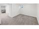 Carpeted basement space with white walls, closet, and access to utility room at 2620 Bellaire St, Denver, CO 80207