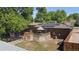 An aerial view of a brick home featuring a deck with solar panels and a backyard at 8178 W 64Th Ave, Arvada, CO 80004