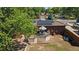 Aerial view of backyard with a deck, solar panels and brick home with a detached garage on the property at 8178 W 64Th Ave, Arvada, CO 80004