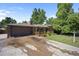 Charming brick home featuring a spacious front yard, an attached two-car garage and a covered porch at 8178 W 64Th Ave, Arvada, CO 80004