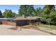 Charming brick home featuring a spacious front yard, an attached two-car garage, a covered porch and solar panels at 8178 W 64Th Ave, Arvada, CO 80004