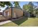 Detached garage with a light tan exterior and green trim featuring an adjacent shed and a grassy yard at 8178 W 64Th Ave, Arvada, CO 80004