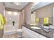 Bathroom features granite countertop, white cabinetry, and shower-tub combo with modern fixtures at 7877 S University Way, Centennial, CO 80122