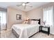 Bedroom with a white bedspread, neutral walls, and a window with white curtains at 7877 S University Way, Centennial, CO 80122
