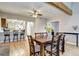 Stylish dining area with hardwood floors, exposed beams, and seamless connection to the kitchen and living area at 7877 S University Way, Centennial, CO 80122