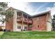 Back exterior view of a brick home with a deck, patio, and landscaped yard at 7877 S University Way, Centennial, CO 80122