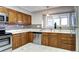 Charming kitchen with stainless steel appliances and oak cabinets providing ample storage space at 7877 S University Way, Centennial, CO 80122
