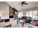 Comfortable living room features a stone fireplace, built-in shelving, plush seating, and lots of natural light at 7877 S University Way, Centennial, CO 80122