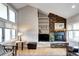 Bright living room area with stone fireplace and vaulted ceilings offers a relaxing space for entertaining at 7877 S University Way, Centennial, CO 80122