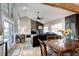 Inviting living room with vaulted ceiling, a stone fireplace, and a wall of windows for ample natural light at 7877 S University Way, Centennial, CO 80122