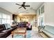 Bright living room with hardwood floors, an exposed beam, lots of windows, and seamless flow to other living areas at 7877 S University Way, Centennial, CO 80122