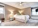 Relaxing main bedroom with ceiling fan, complemented by soft lighting from bedside lamps at 7877 S University Way, Centennial, CO 80122