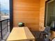 Relaxing balcony area featuring wood paneling, outdoor dining, and mountain views at 2718 Pine St # 305, Boulder, CO 80302