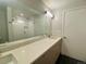 Elegant bathroom featuring a vanity with stone countertop, a large mirror and a shower in the reflection at 2718 Pine St # 305, Boulder, CO 80302